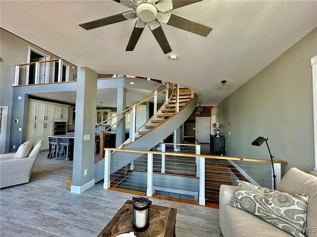 2 Perch Bay Rd, Morristown, NY 13669 - living room with wood finished floors, ceiling fan, stairway, and baseboards