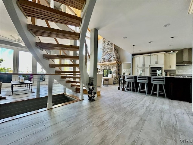 2 Perch Bay Rd, Morristown, NY 13669 - stairway with wood finished floors, a ceiling fan, and high vaulted ceiling