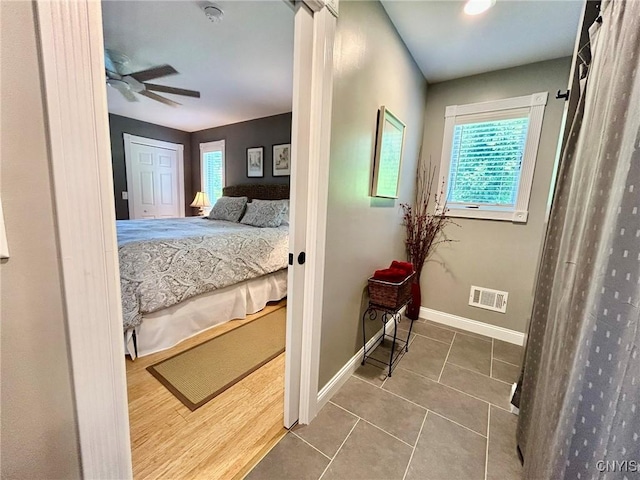 2 Perch Bay Rd, Morristown, NY 13669 - tiled bedroom featuring multiple windows, baseboards, and a ceiling fan