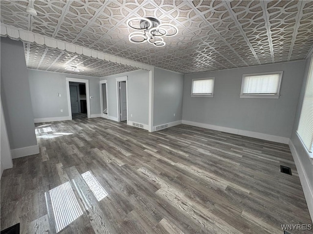 354 Schenck St, North Tonawanda, NY 14120 - below grade area with an ornate ceiling, baseboards, and wood finished floors