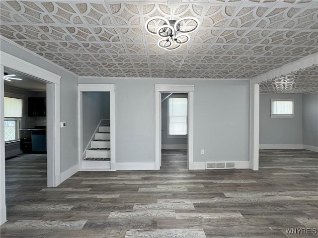 354 Schenck St, North Tonawanda, NY 14120 - below grade area featuring baseboards, wood finished floors, stairs, an ornate ceiling, and a chandelier