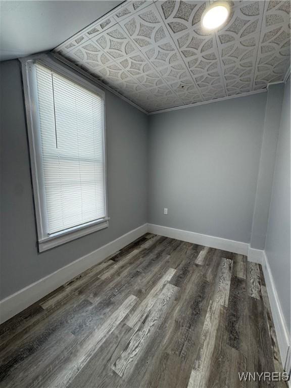 354 Schenck St, North Tonawanda, NY 14120 - unfurnished room with wood finished floors, baseboards, and an ornate ceiling