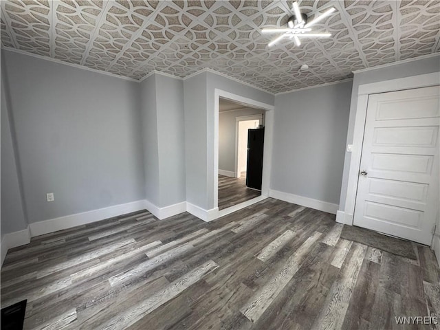 354 Schenck St, North Tonawanda, NY 14120 - spare room with an ornate ceiling, baseboards, dark wood-style floors, and ornamental molding