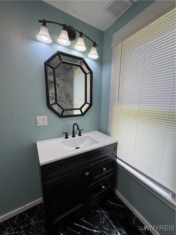 354 Schenck St, North Tonawanda, NY 14120 - bathroom featuring marble look tile flooring, baseboards, and vanity