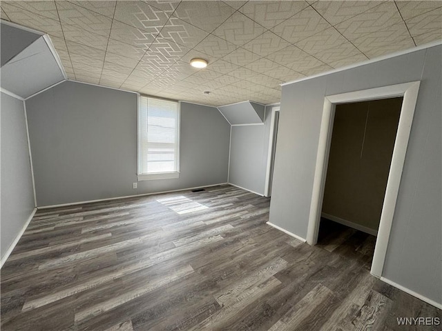 354 Schenck St, North Tonawanda, NY 14120 - additional living space with lofted ceiling, dark wood finished floors, and baseboards
