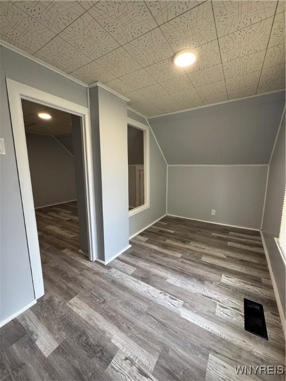 354 Schenck St, North Tonawanda, NY 14120 - additional living space with lofted ceiling, wood finished floors, baseboards, and an ornate ceiling