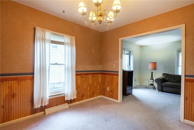 376 Imperial Ave, Erwin, NY 14870 - spare room featuring a chandelier, a wainscoted wall, a baseboard heating unit, carpet, and wood walls