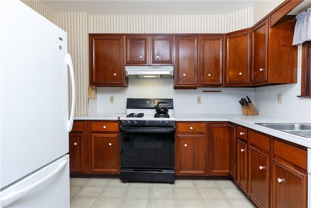 376 Imperial Ave, Erwin, NY 14870 - kitchen with freestanding refrigerator, under cabinet range hood, gas range oven, light floors, and light countertops
