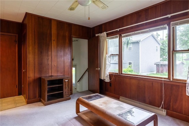 376 Imperial Ave, Erwin, NY 14870 - living room featuring baseboard heating, wood walls, light colored carpet, and a ceiling fan