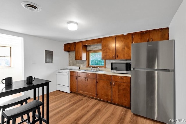 10652 Elm St, North Collins, NY 14111 - kitchen featuring stainless steel appliances, a sink, light countertops, and brown cabinetry