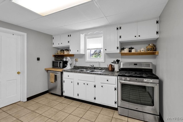 10652 Elm St, North Collins, NY 14111 - kitchen with stainless steel appliances, open shelves, a sink, dark countertops, and white cabinetry