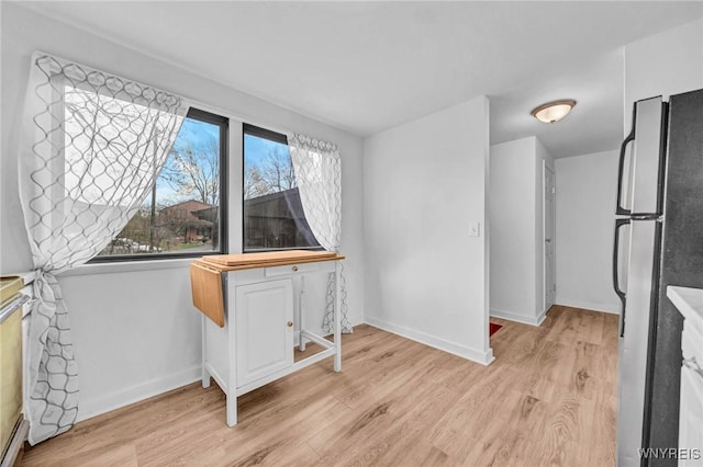 8 Robin Rd, Amherst, NY 14228 - unfurnished dining area featuring light wood finished floors and baseboards