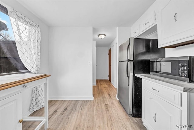 8 Robin Rd, Amherst, NY 14228 - kitchen featuring stainless steel appliances, light wood finished floors, white cabinets, light countertops, and baseboards