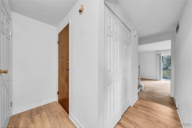 8 Robin Rd, Amherst, NY 14228 - hallway featuring light wood-style flooring, baseboards, and an upstairs landing
