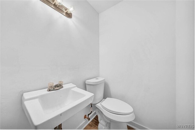 8 Robin Rd, Amherst, NY 14228 - bathroom featuring wood finished floors, a sink, toilet, and baseboards