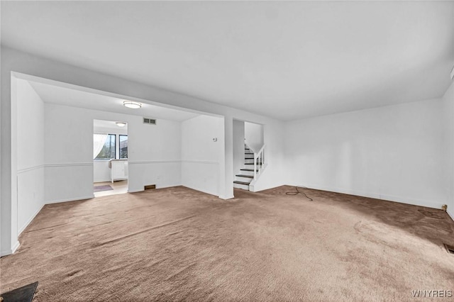 8 Robin Rd, Amherst, NY 14228 - unfurnished living room with carpet flooring, stairs, and baseboards