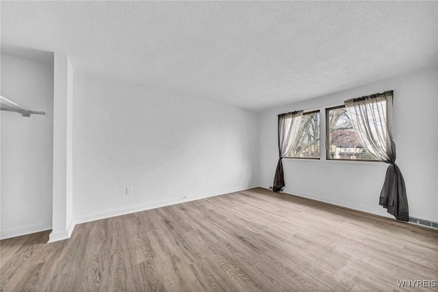 8 Robin Rd, Amherst, NY 14228 - unfurnished bedroom featuring a textured ceiling, wood finished floors, and baseboards