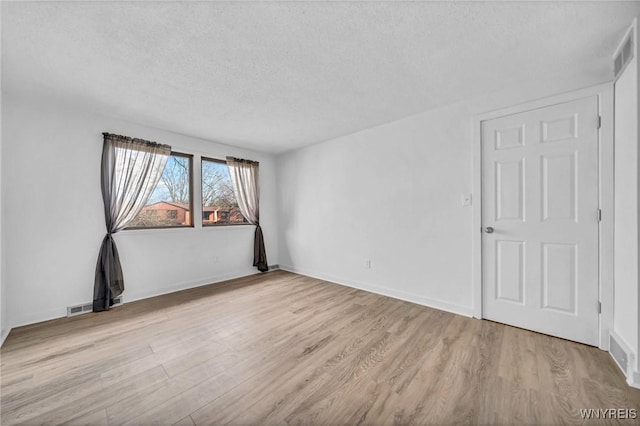8 Robin Rd, Amherst, NY 14228 - spare room with wood finished floors, a textured ceiling, and baseboards