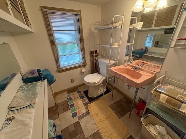 106 Rexford St, Rochester, NY 14621 - bathroom with toilet, baseboards, and stone finish flooring