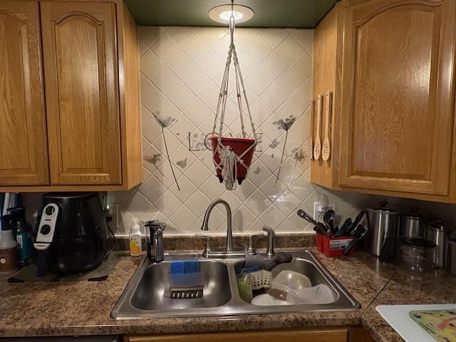 106 Rexford St, Rochester, NY 14621 - kitchen with a sink, backsplash, and dark countertops