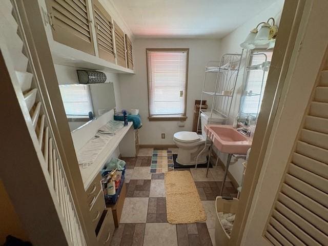 106 Rexford St, Rochester, NY 14621 - bathroom with a sink, toilet, and baseboards