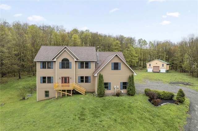 2779 Maricle Rd, Freetown, NY 13040 - rear view of property featuring a lawn, a forest view, an outdoor structure, a garage, and a wooden deck