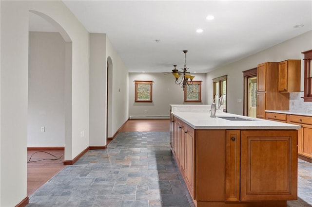 2779 Maricle Rd, Freetown, NY 13040 - kitchen with arched walkways, a sink, baseboards, light countertops, and recessed lighting