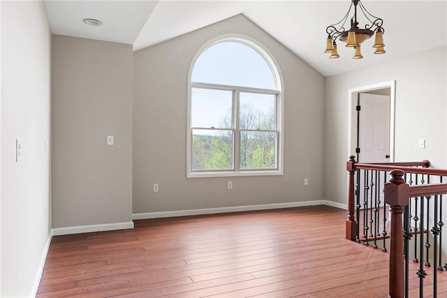 2779 Maricle Rd, Freetown, NY 13040 - unfurnished room with a chandelier, lofted ceiling, wood finished floors, and baseboards