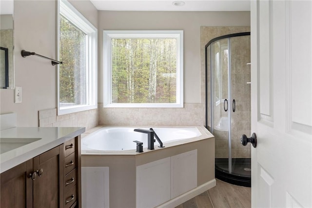 2779 Maricle Rd, Freetown, NY 13040 - bathroom featuring vanity, a stall shower, a garden tub, and wood finished floors