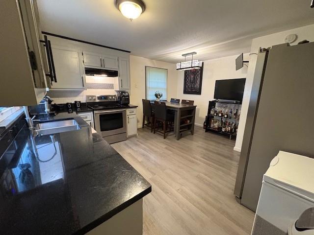 245 Weaver St, Rochester, NY 14621 - kitchen featuring appliances with stainless steel finishes, under cabinet range hood, dark countertops, and a sink