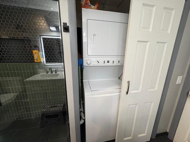 245 Weaver St, Rochester, NY 14621 - washroom featuring stacked washer / dryer and tile patterned flooring