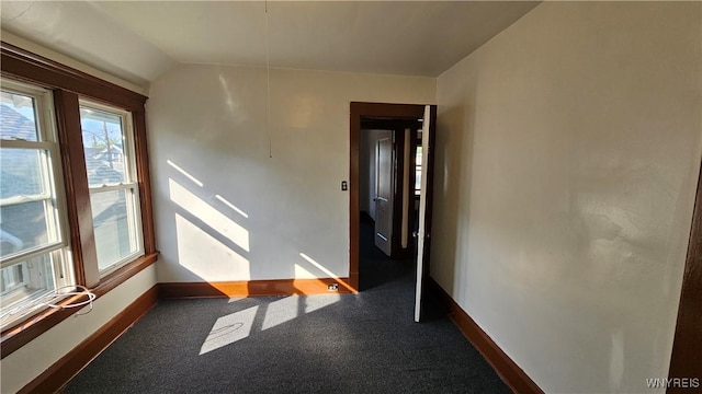 341 Dartmouth Ave, Buffalo, NY 14215 - unfurnished room with baseboards, carpet floors, and vaulted ceiling