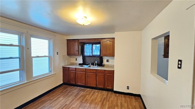341 Dartmouth Ave, Buffalo, NY 14215 - kitchen featuring a sink, light countertops, tasteful backsplash, light wood finished floors, and healthy amount of natural light