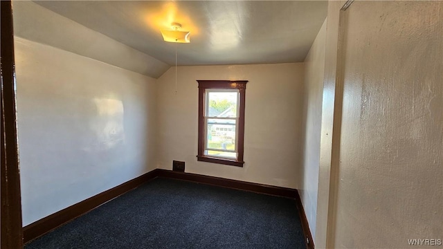 341 Dartmouth Ave, Buffalo, NY 14215 - empty room featuring dark carpet, baseboards, and vaulted ceiling