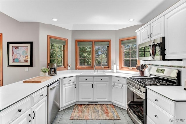 23 Gatehouse Ln, Amherst, NY 14051 - kitchen with appliances with stainless steel finishes, a sink, light countertops, recessed lighting, and white cabinetry