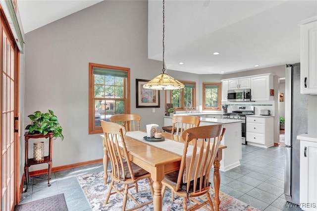 23 Gatehouse Ln, Amherst, NY 14051 - dining room with plenty of natural light, lofted ceiling, light tile patterned floors, recessed lighting, and baseboards