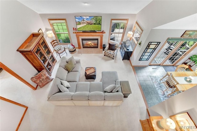 23 Gatehouse Ln, Amherst, NY 14051 - living room featuring plenty of natural light, a glass covered fireplace, and baseboards