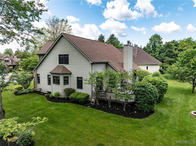 23 Gatehouse Ln, Amherst, NY 14051 - rear view of house featuring a wooden deck, a yard, a chimney, and roof with shingles