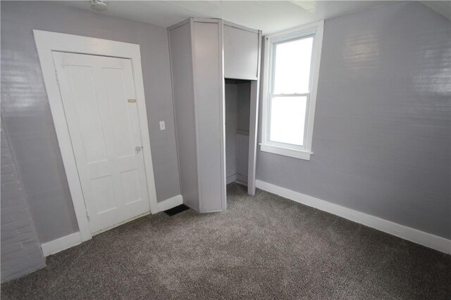 569 Washington Ave, Irondequoit, NY 14617 - unfurnished bedroom featuring carpet flooring, baseboards, and a closet