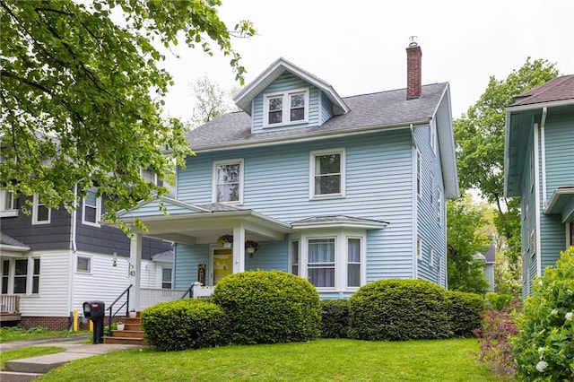 43 Woodland Park, Rochester, NY 14610 - american foursquare style home featuring a chimney, a front yard, a porch, and roof with shingles