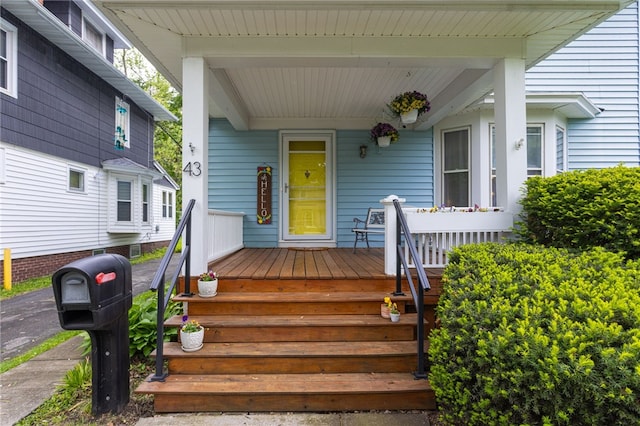 43 Woodland Park, Rochester, NY 14610 - doorway to property with a porch