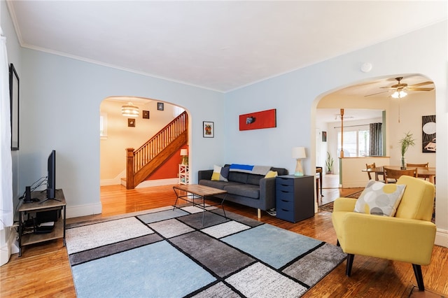 43 Woodland Park, Rochester, NY 14610 - living area featuring arched walkways, wood finished floors, stairway, a ceiling fan, and crown molding