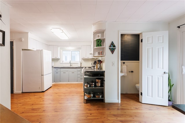 43 Woodland Park, Rochester, NY 14610 - kitchen with freestanding refrigerator, open shelves, a sink, and backsplash