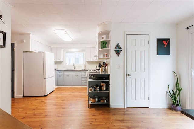 43 Woodland Park, Rochester, NY 14610 - kitchen featuring freestanding refrigerator, open shelves, a sink, light wood-type flooring, and white cabinetry