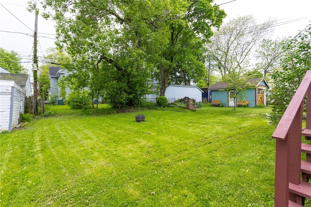 43 Woodland Park, Rochester, NY 14610 - view of grassy yard featuring an outdoor fire pit