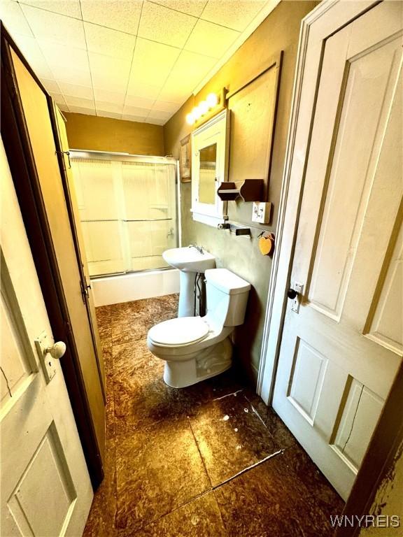 6723 Akron Rd, Lockport Town, NY 14094 - bathroom featuring toilet and shower / bath combination with glass door