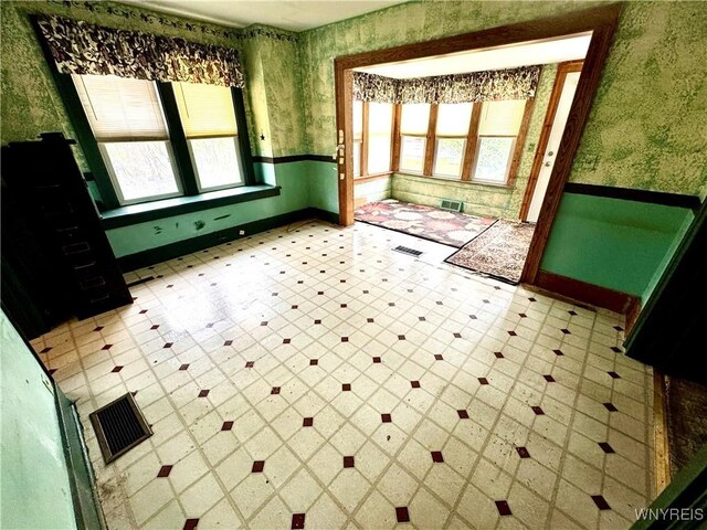 6723 Akron Rd, Lockport Town, NY 14094 - unfurnished room featuring wallpapered walls, light floors, and baseboards