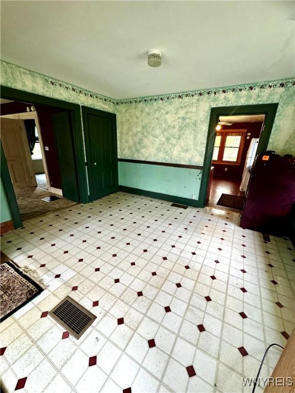 6723 Akron Rd, Lockport Town, NY 14094 - spare room with wallpapered walls, light flooring, and baseboards