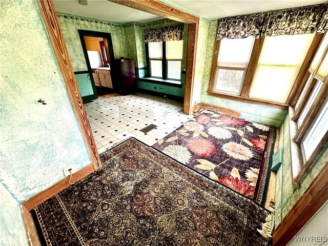 6723 Akron Rd, Lockport Town, NY 14094 - unfurnished room with wallpapered walls, baseboards, and tile patterned floors