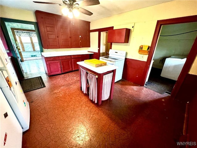 6723 Akron Rd, Lockport Town, NY 14094 - kitchen featuring white appliances, washer / clothes dryer, a ceiling fan, light countertops, and dark flooring